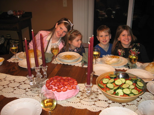 Soup in bread bowls with fresh green and fruit salads