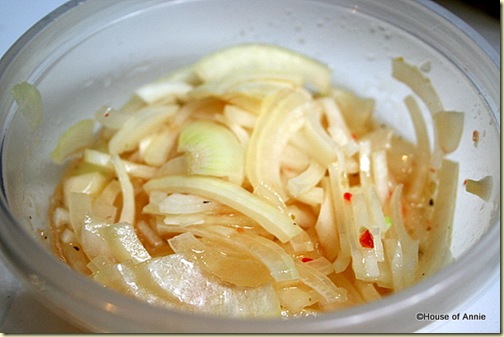 Thinly sliced onion marinating in Italian dressing