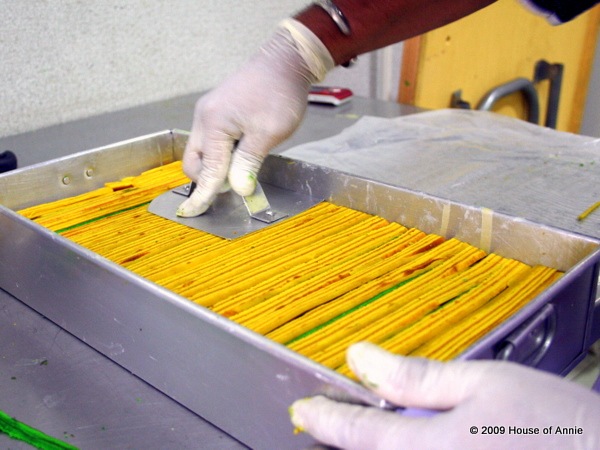 [pressing down last layer of yellow strips to make the sarawak layer cake level - copyright house of annie[2].jpg]