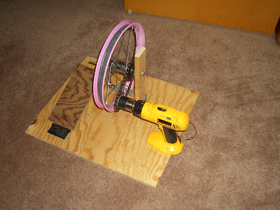 I realized after setting it up like this and then testing it that the force from the chain on the drill chuck caused the plastic drill body to bend so I had to modify the setup by laying th drill horizontally and attaching it to the base with large hose clamps