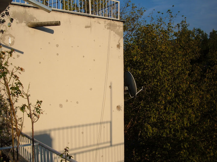 Bullet Holes from the War on Bens Apartments Outer Wall