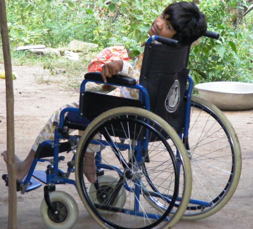 Socheat on her new wheelchair donated by Barton Brooks, President of GC