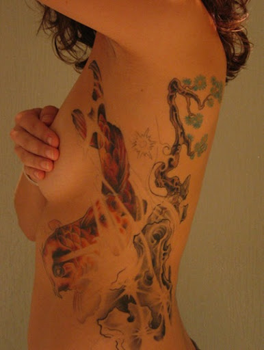 japanese goldfish tattoo. japanese koi ribcage tattoo