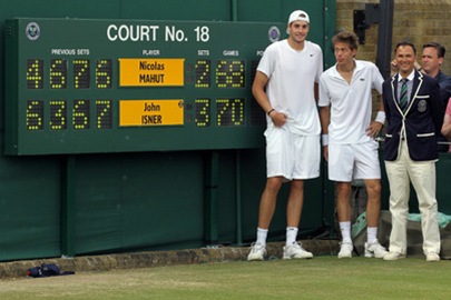 LONDON, ENGLAND - JUNE 24:  John Isner of USA (L) poses after winning on the third day of his first round match against Nicolas Mahut of France (C) with Chair Umpire Mohamed Lahyani on Day Four of the Wimbledon Lawn Tennis Championships at the All England Lawn Tennis and Croquet Club on June 24, 2010 in London, England. The match is the longest in Grand Slam history.  (Photo by Hamish Blair/Getty Images)