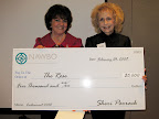 Sheri Parrack, NAWBO Houston President, presents Dorothy Gibbons, Co-Founder of The Rose with a check for $5,000.