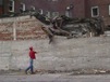 Andrew Noonan throws debris back into a pile