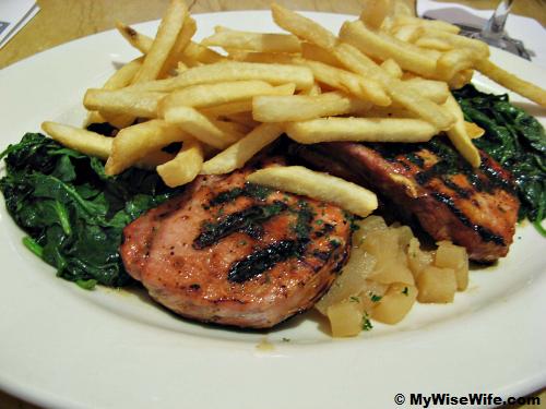 Grilled pork with apple sauce, vegetables and fries Grilled pork with apple sauce, vegetables and fries