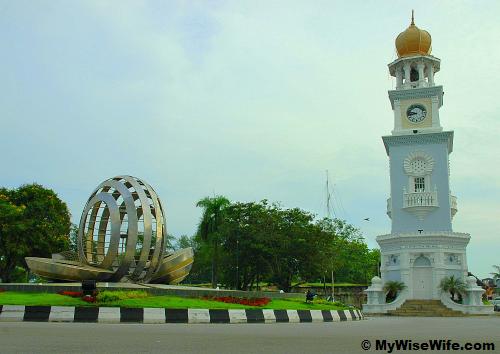The historic Queen Victoria Clock Tower with modern-looking betel nut sculpture