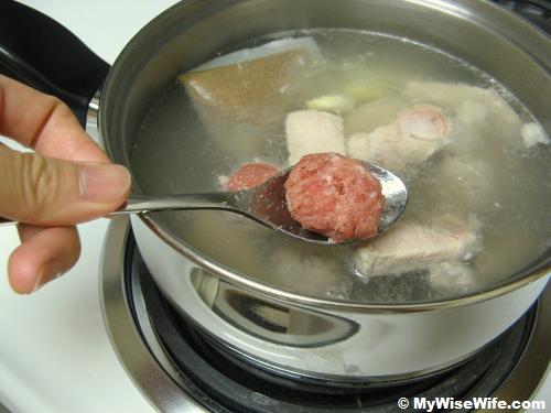 The meat ball is going into hot soup The meat ball is going into hot soup