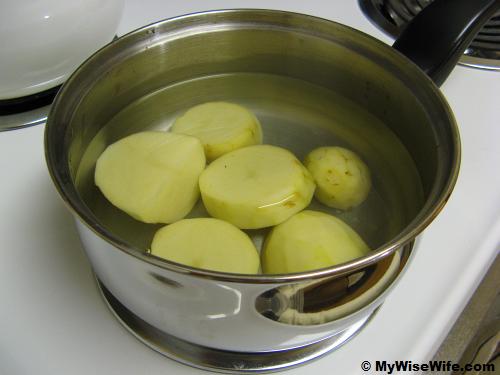 Big pieces of potatoes in saucepan Big pieces of potatoes in saucepan