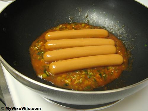 Sausages dipped in BBQ sauce Sausages dipped in BBQ sauce