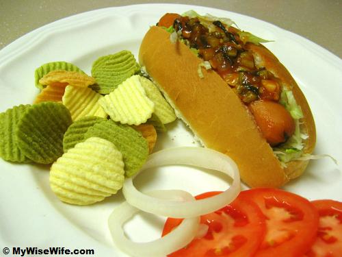Hotdog with chips, fresh onion and tomato Hotdog with chips, fresh onion and tomato