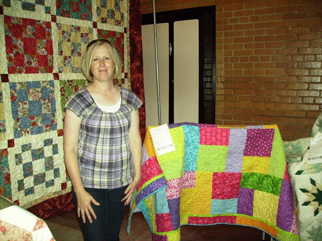 [Jodi S with daughter's quilt[2].jpg]