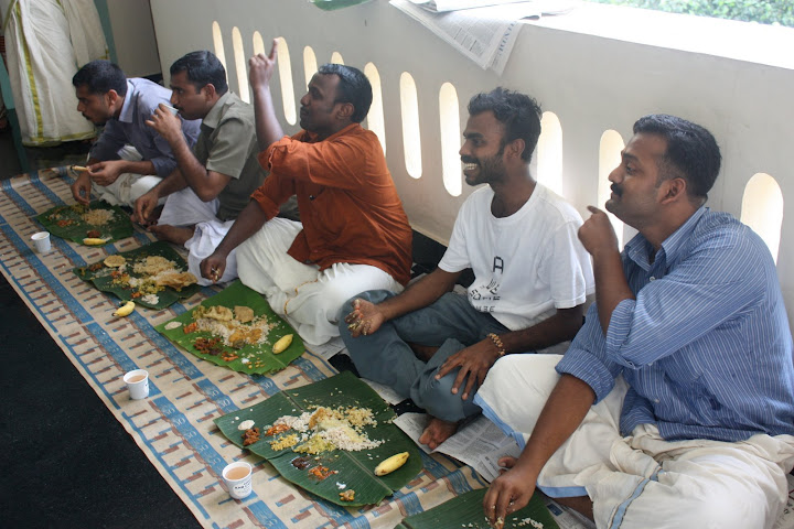 Several SES students eating the traditional Onam meal