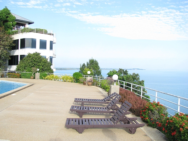 One of the swimming pools at the Hin Suay Nam Sai resort estate near Mae Phim, Rayong, Thailand, with a panoramic view of the ocean.
