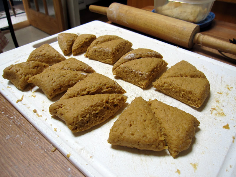 Heres how I cut the dough to make the mini scones. I rolled out the dough into a rectangle, then cut it down the middle forming two long pieces. I made three cuts across each of the long pieces, then I cut the resulting squares along the diagonal. And voila! Little triangle scones!
