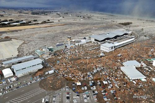 Tarmac, parking lot and surrounding area are covered with mud and debris carried by tsunami at Sendai Airport in Sendai, Miyagi Prefecture (state) after Japan was struck by a strong earthquake off its northeastern coast Friday, March 11, 2011. (AP Photo/Kyodo News) JAPAN OUT, MANDATORY CREDIT, FOR COMMERCIAL USE ONLY IN NORTH AMERICA