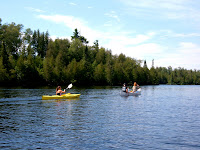 Erika in the kayak, Connie and Larry in the canoe going for a picnic on Poplar Lake.