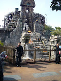 Host father posing in front of a fake ruin thing.