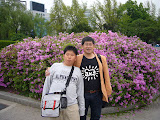 Host father and brother in front of garden.