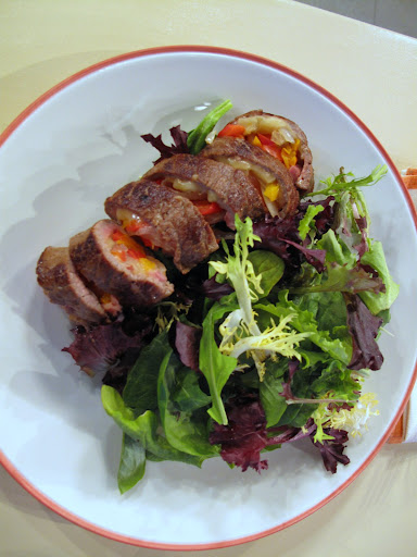 Once they're sauteed in a bit of olive oil, the rolls are sliced and served with mixed greens.