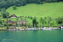 White and blue sailing boats at the shore of Lake Lucerne in Switzerland - Thumbnail
