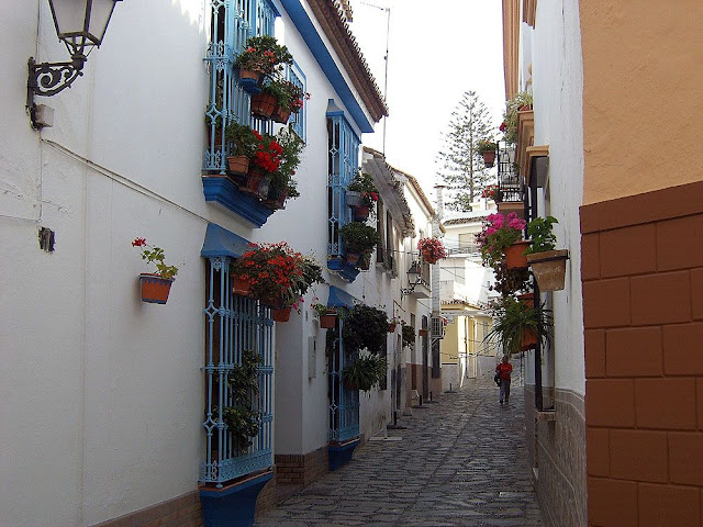 Typical Mediterranean. White buildings, coloured windows - and narrow cobbled streets