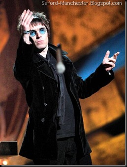 Liam Gallagher pictured throwing a microphone into the crowd at the Brit Awards