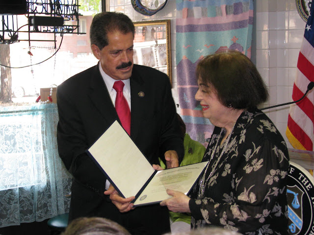 Congressman Jos&eacute; Serrano, handing Bethex FCU President & CEO Joy Cousminer with a $750,000 award from the U.S. Treasury Department's CDFI Fund.