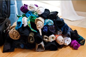 Tightly roll the clothes individually Tightly roll the clothes individually
