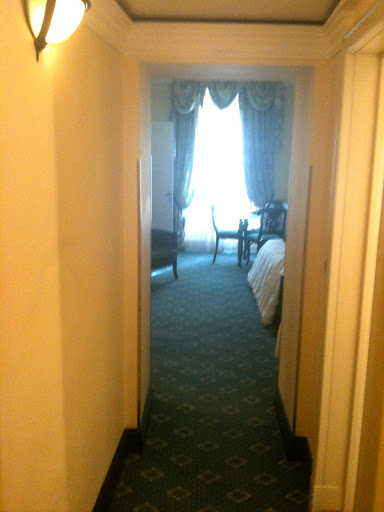 a hallway with a bed and chairs