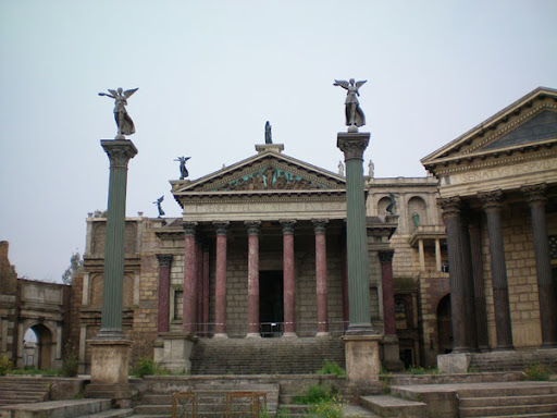a stone building with columns and statues