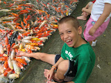 Zach is letting the fish taste his toes