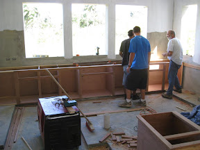 Aria, Chris and Mike install the base cabinets.