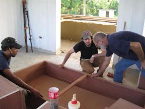 Andy, Mike and Aria working on one of the overhead cabinets.