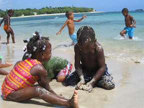 Kamila and Son building a sand castle.