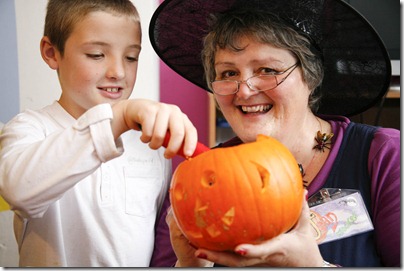 Webby's Community Centre - Frank Webb Avenue Crewe - Connor Brock helps artist Jean Crocker to carve out  a pumpkin