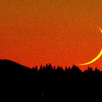 Moon on the horizon at sunset. Colors saturated and noise exaggerated for effect.