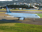 Air New Zealand Airbus A320, with control tower in background