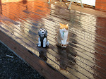 Bangsi our cat sitting next to the statue of a dog.