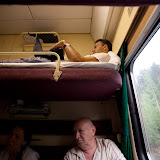 Roman takes a break on the upper bunk as the rest of us talk below (on the train to Krasnoyarsk)