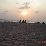 The sun is beginning to set. However here you can't drink on the beach as there is a temple nearby.