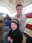 Daddy and Mason on the hayride out to the pumpkin fields
