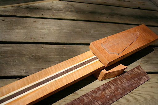 Neck laminates from the outside in: figured mahogany, birdseye maple, figured katalox core.