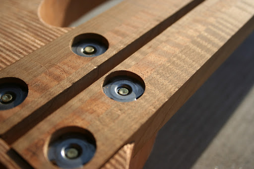 A close-up of the neck fastening system that will be used on all Decibel bolt-on instruments. These are 1/4"-20 T-nuts embedded in the neck.