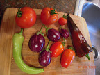 Early girls, couple kibits tomatoes, an unripe banana pepper, 4 twinkle eggplant, semi-ripe carmen pepper (v sweet)