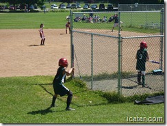 Annalise watches the pitcher as she waits on deck.