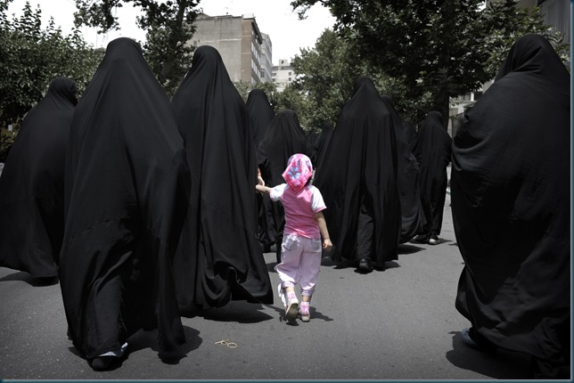  Iranian women walk in a street before the speech of Iran's supreme leader Ayatollah Ali Khamenei outside the Tehran University, on June 19, 2009. Making his first public appearance after daily protests over the official results, Khamenei spoke at the weekly Muslim prayers, called for an end to street protests over last week's disputed presidential election, and sided with declared winner Mahmoud Ahmadinejad.