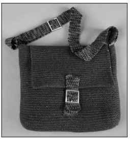 The felted messenger bag has linen stitch straps.