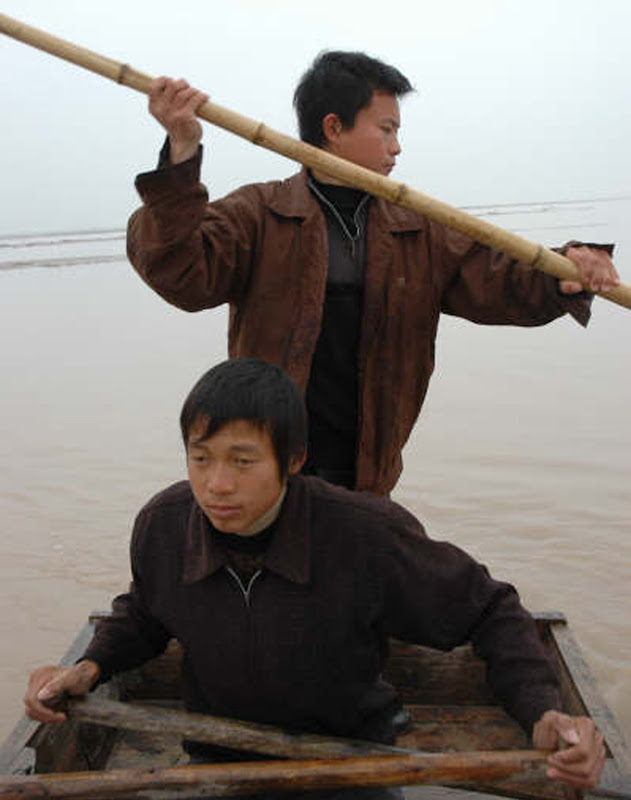 A scene from He Jianjun's portrait of two young Chinese fisherman, RIVER PEOPLE A scene from He Jianjun's portrait of two young Chinese fisherman, RIVER PEOPLE